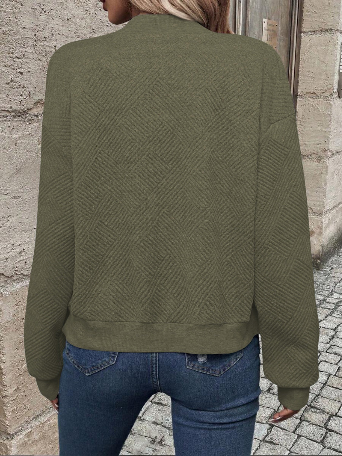 Army green bomber jacket with geometric quilted pattern and ribbed cuffs and hem.
