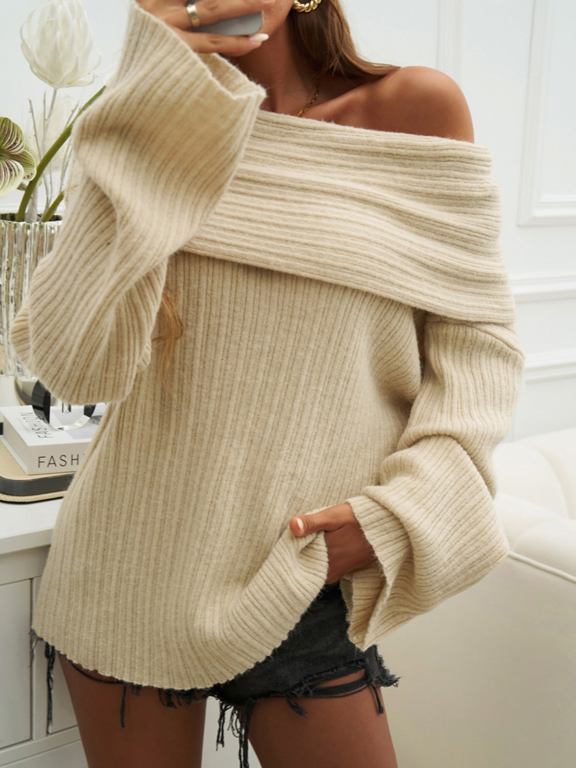 Beige ribbed knit off-the-shoulder sweater with wide sleeves and a relaxed cocoon fit.