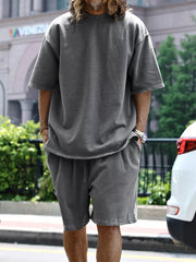 Men's relaxed fit two-piece set in dark gray with drawstring shorts and a crewneck tee.