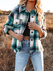Plaid pocket long sleeve shirt jacket in dark green and black with button details.
