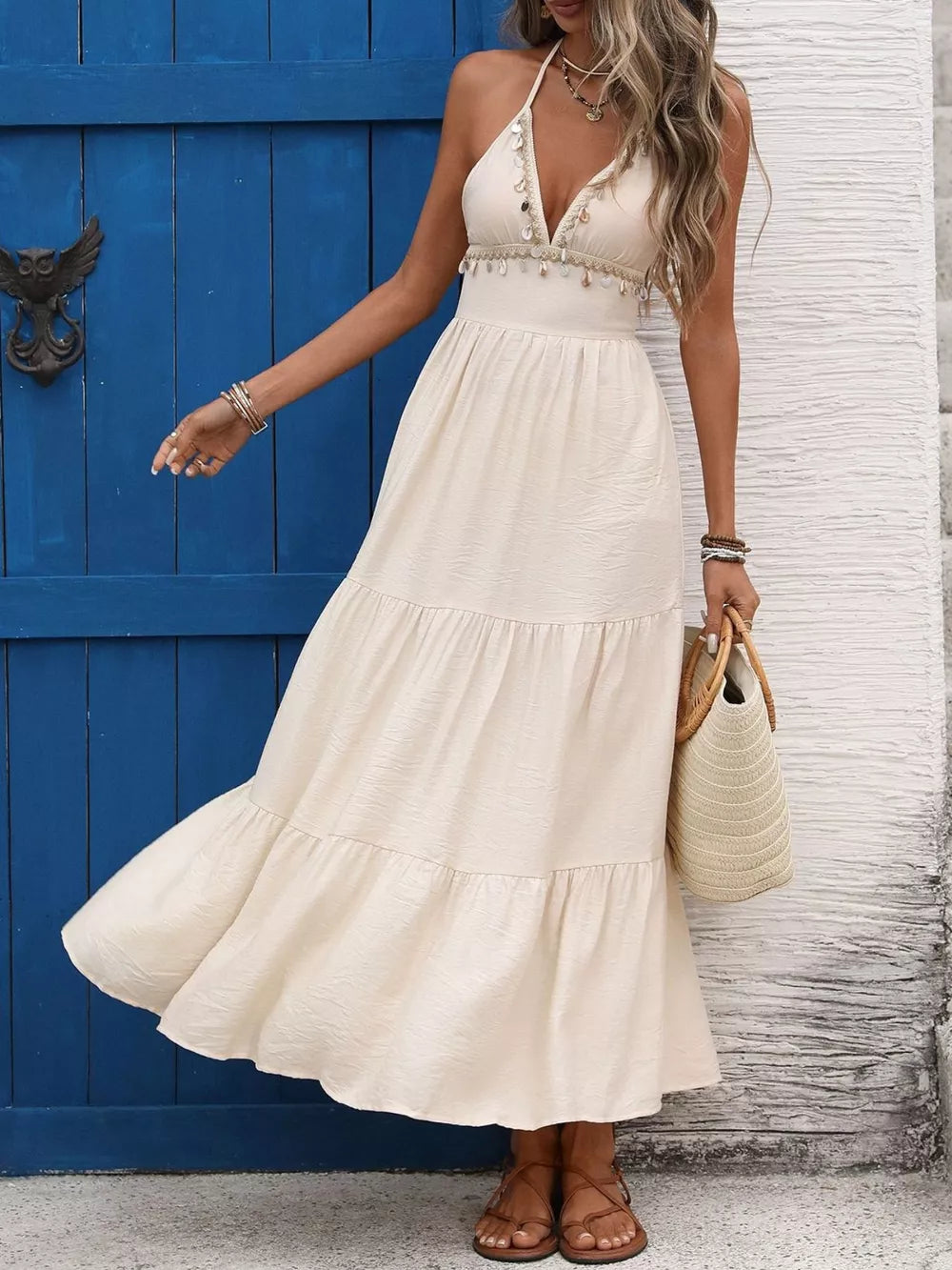 Bohemian halter maxi dress in apricot with tiered skirt and beaded neckline detail.