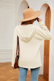 Cream textured henley hoodie with drop shoulder and long sleeves.