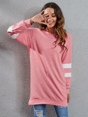 Varsity stripe raglan sweatshirt dress in burnt coral with white sleeve stripes.