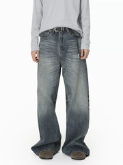 Men's wide leg denim jeans in washed blue with a relaxed fit and gradient fade.