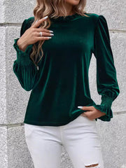 Dark green velvet blouse with blouson sleeves, ruffled neckline and smocked cuffs.