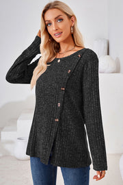 Black ribbed knit top with asymmetric button detail and crew neck.