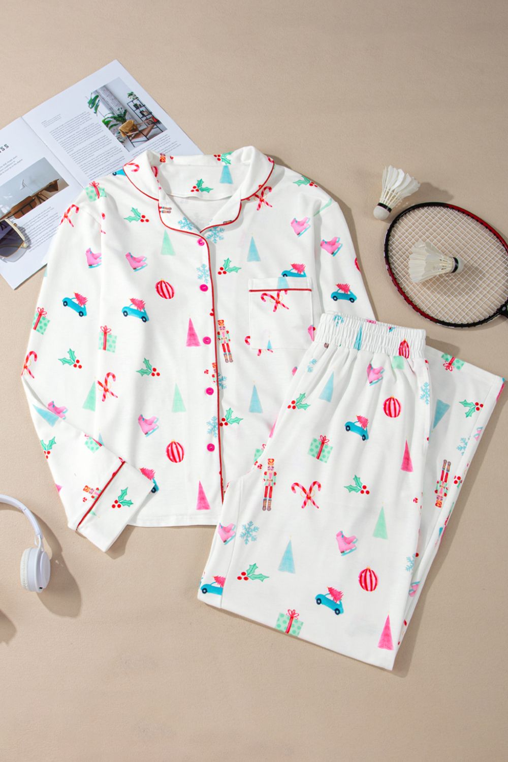 White festive print pajama set with contrast trim, long sleeves, button front, and pants.