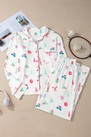 White festive print pajama set with contrast trim, long sleeves, button front, and pants.