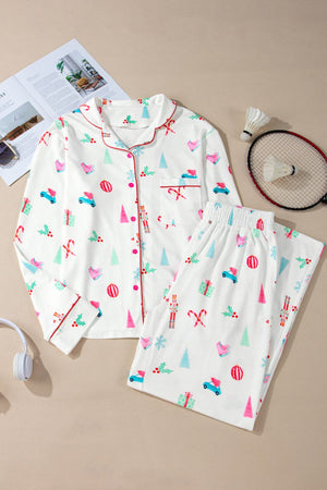 White festive print pajama set with contrast trim, long sleeves, button front, and pants.