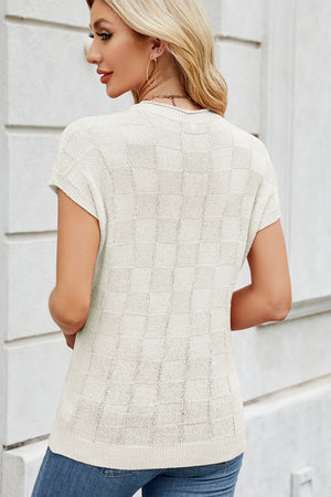 Ivory textured knit top with short sleeves and a checkered pattern.