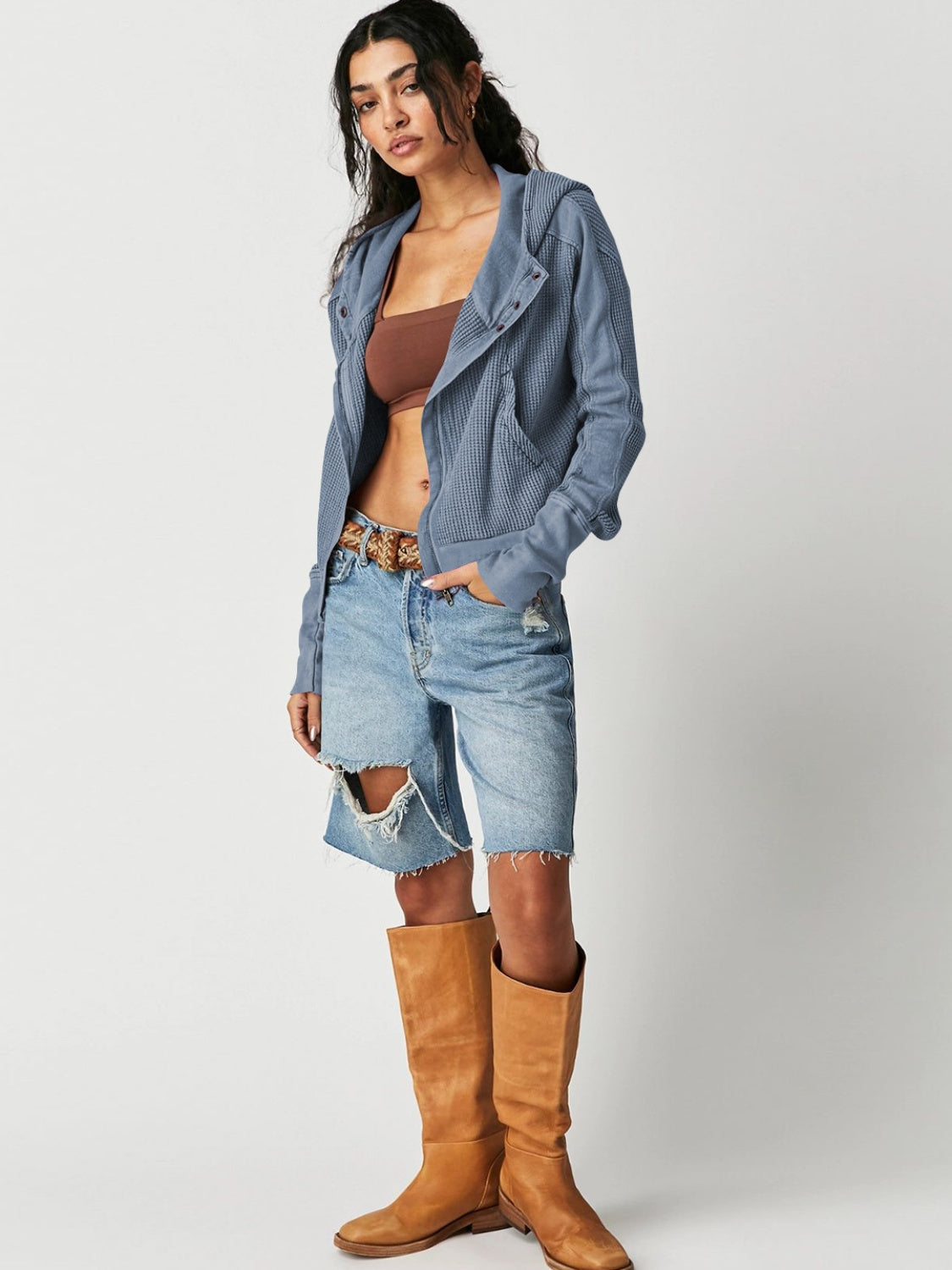 Dusty blue waffle knit cropped hoodie with snap front and hood, styled with denim shorts.