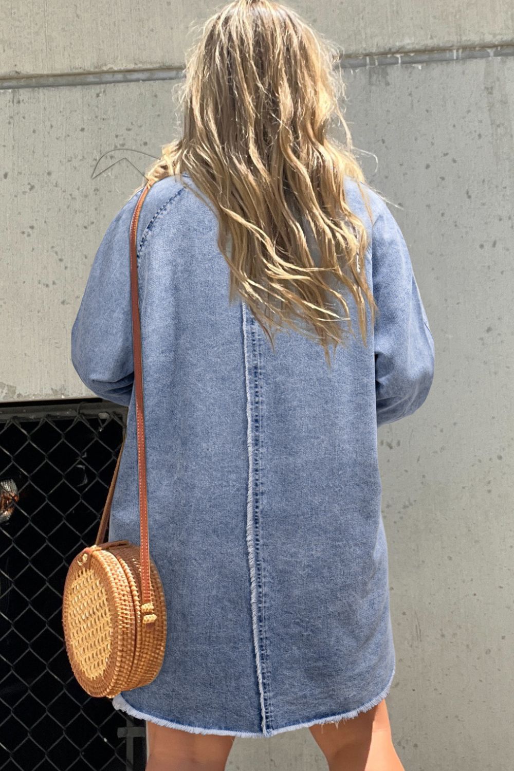 Acid wash denim shirtdress with raw hem, medium color, cotton, with a crossbody rattan bag.