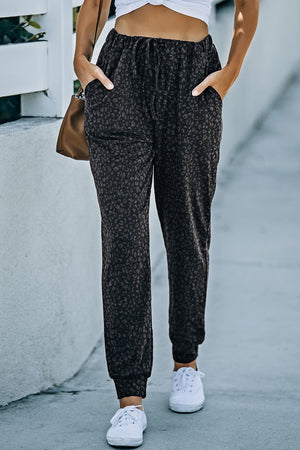 Shadow Leopard Relaxed-Fit Drawstring Trousers in Black with pockets and cuffed ankles.