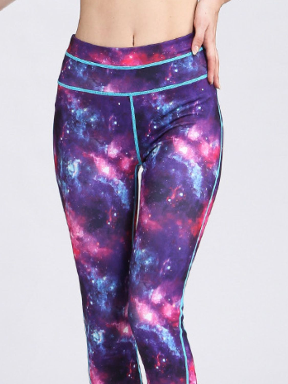 Purple cosmic print contour leggings with blue piping and a high waist.