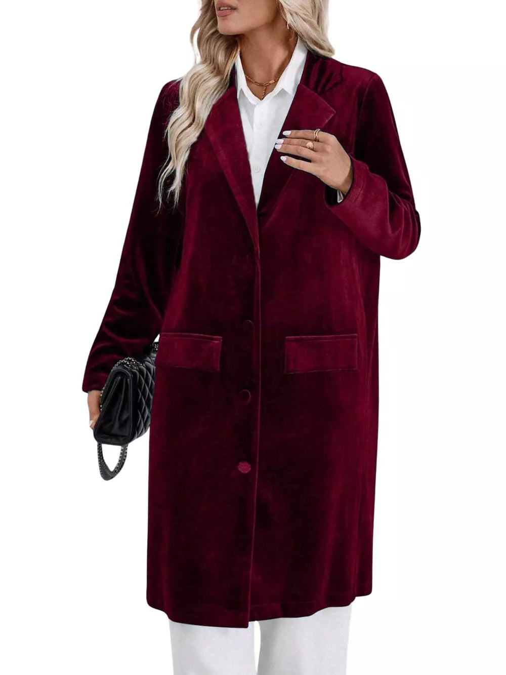 Burgundy velvet longline trench coat with lapel collar, buttoned front, and flap pockets.
