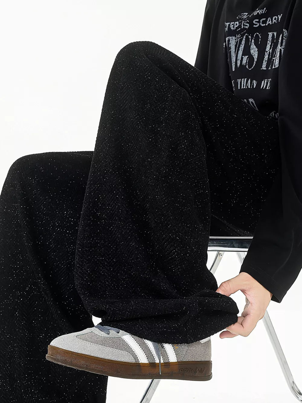 Black textured knit sweatpants with a subtle sparkle detail, shown on a model.