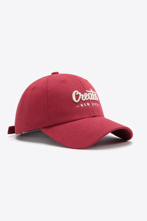 Deep Red baseball cap with embroidered "Create New Life" text, adjustable strap.