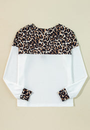 White waffle knit henley sweater with leopard print yoke and cuffs