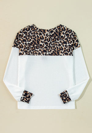 White waffle knit henley sweater with leopard print yoke and cuffs