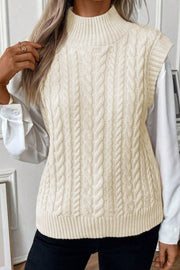 Ivory cable knit mock neck vest with chunky texture.