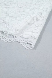 White lace blouse with ruffled hem detail