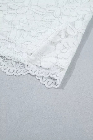 White lace blouse with ruffled hem detail