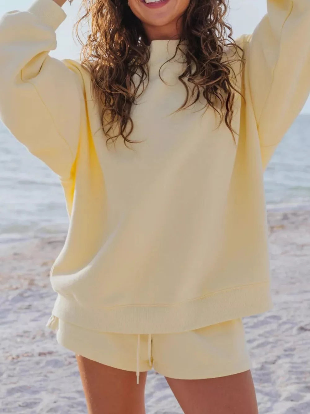 Yellow crew neck sweatshirt and drawstring shorts lounge set on beach