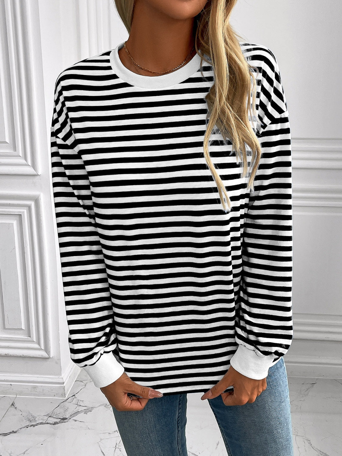 Horizontal stripe crewneck sweatshirt with white cuffs and crew neckline.