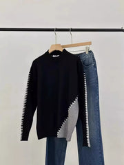 Black mock neck sweater with gray color block and contrast stitching detail.