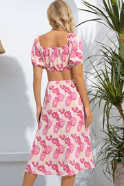 Pink floral midi dress with puff sleeves and cutout detail