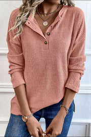 Dusty pink ribbed henley knit top with button detail and relaxed fit.