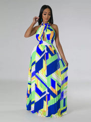 Halter neck pleated maxi dress with bold geometric print and cutout detail.
