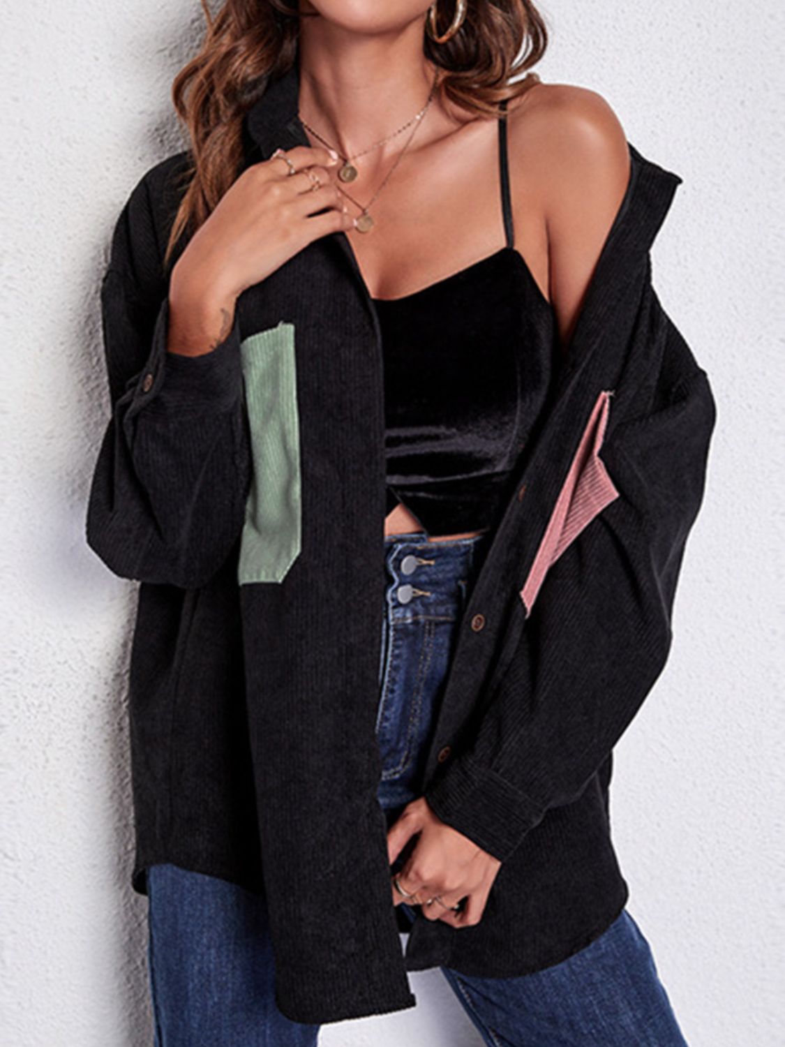 Black corduroy overshirt with contrast patch pockets and button cuffs.