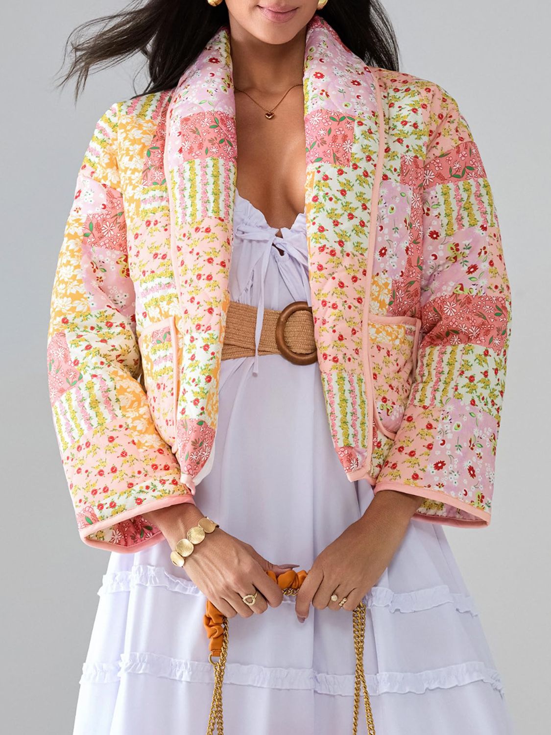 Floral quilted patchwork jacket in pink and yellow with a shawl collar and pockets.