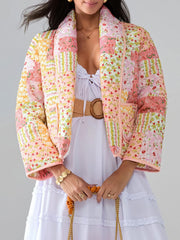 Floral quilted patchwork jacket in pink and yellow with a shawl collar and pockets.