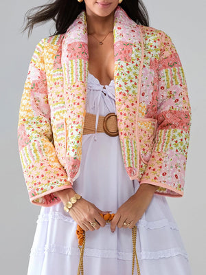 Floral quilted patchwork jacket in pink and yellow with a shawl collar and pockets.