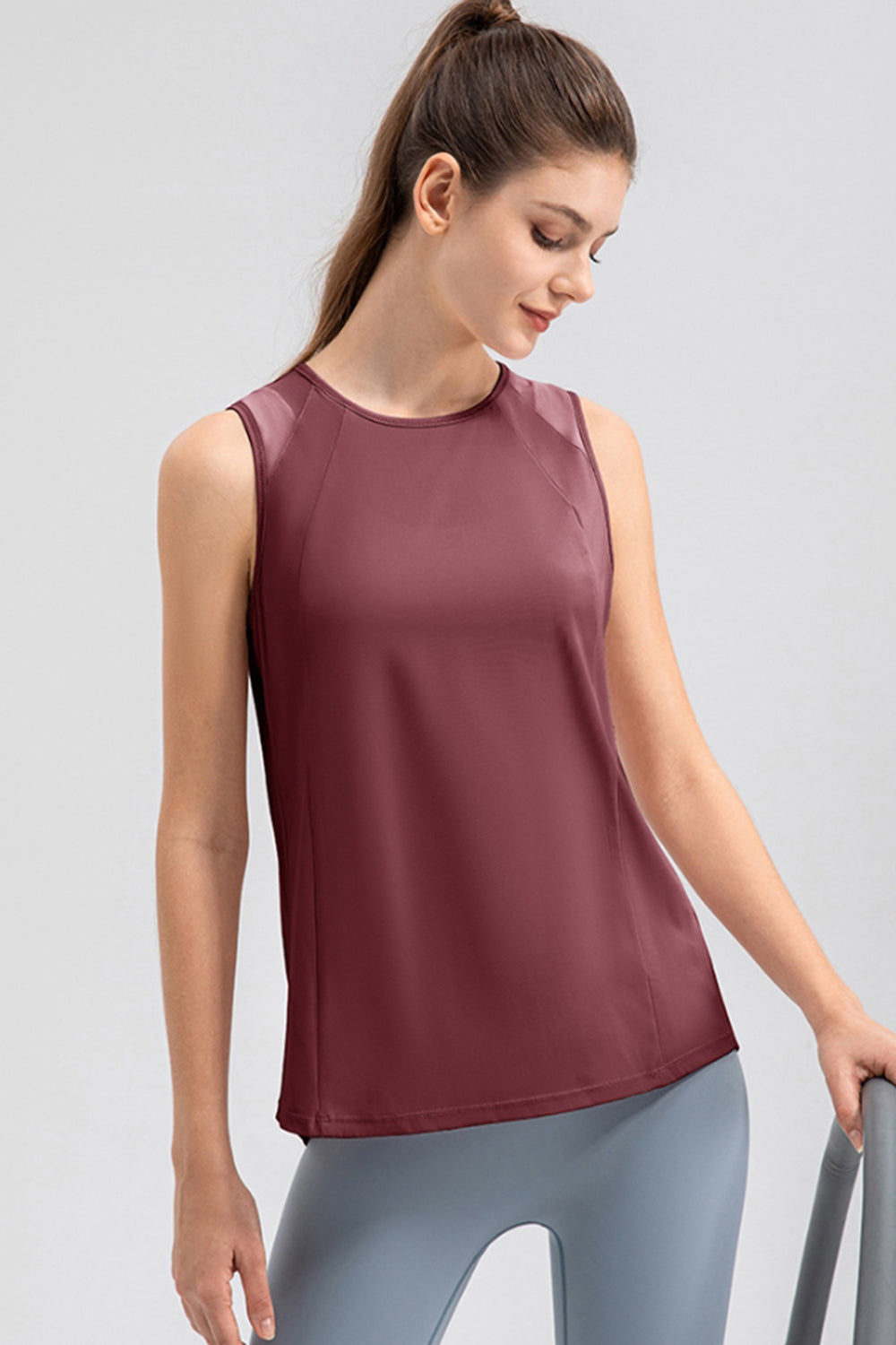 Burgundy mesh panel performance tank top with round neckline and sleeveless design.