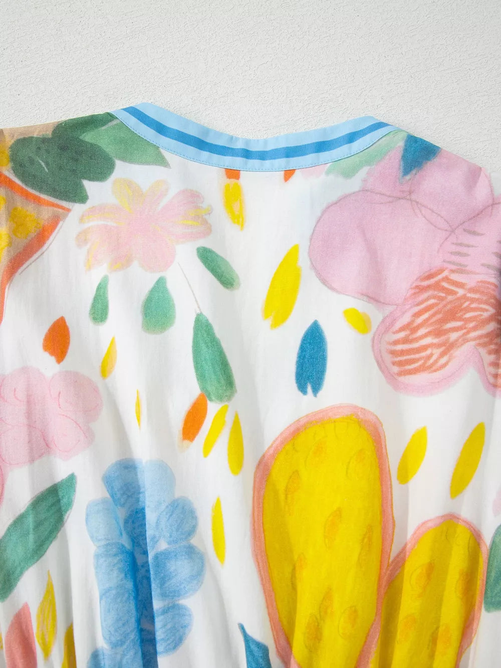 Midi dress with whimsical floral doodle print, 3/4 sleeves, and blue striped neckline.