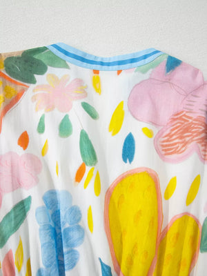 Midi dress with whimsical floral doodle print, 3/4 sleeves, and blue striped neckline.