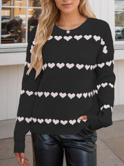 Black knit sweater with white heart stripes, crew neck, long sleeves.