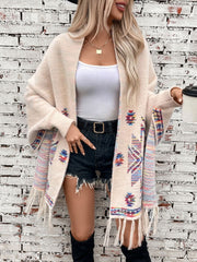 Cream Aztec fringe knit cardigan with colorful geometric pattern and fringe detail.
