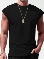 Black muscle fit sleeveless tee with wide shoulders, crew neck, worn with a dog tag necklace.