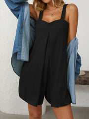 Black pleated bodice romper with sweetheart neckline and wide straps, styled with a denim shirt.