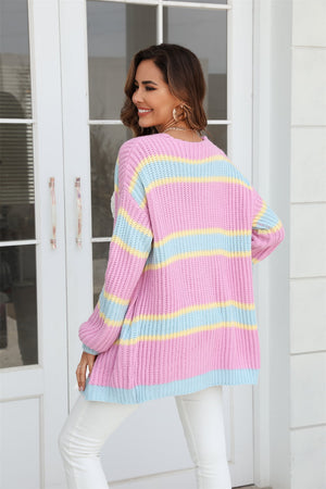 Open knit cocoon cardigan in pink with rainbow stripes, featuring a relaxed fit and long sleeves.