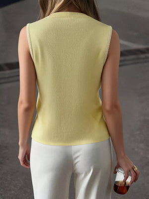 Yellow knit vest with ribbed trim, crew neck, and sleeveless design.