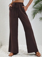 Textured palazzo trousers in dark brown with drawstring waist and wide legs.