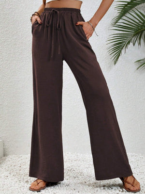 Textured palazzo trousers in dark brown with drawstring waist and wide legs.