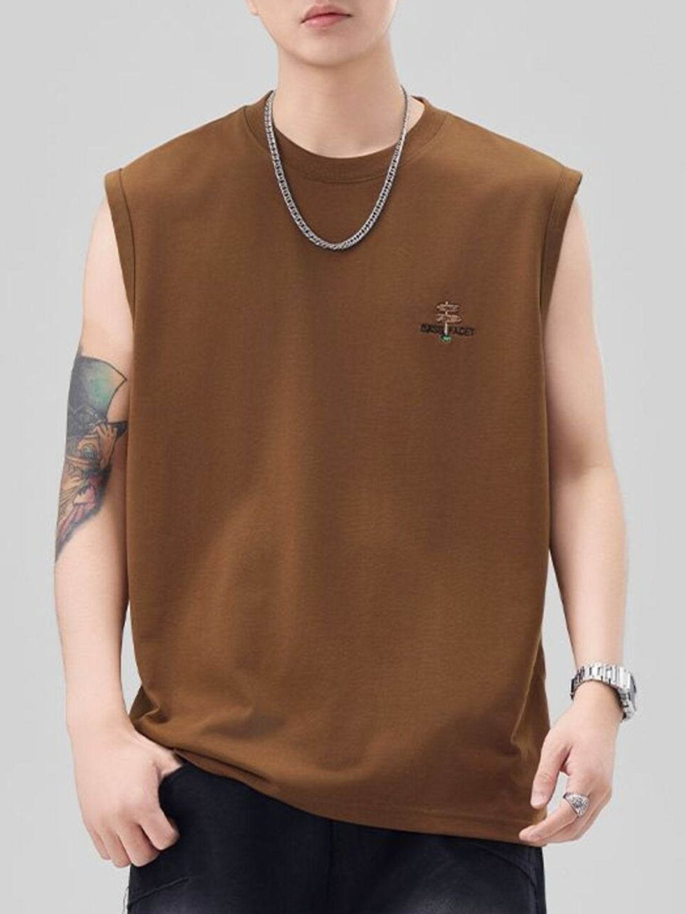 Men's oversized caramel cotton tank top with embroidered logo detail on chest.