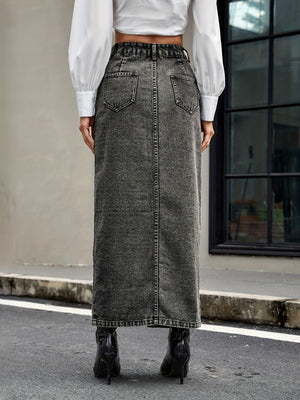 Dark gray denim maxi skirt with button front and slit, styled with a white shirt and black boots.