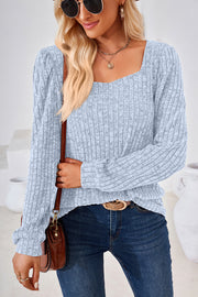Light blue ribbed top with puffed sleeves and square neckline